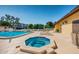 Community pool and hot tub area with surrounding lounge chairs at 5817 Park N St # 204, St Petersburg, FL 33709
