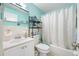 Bathroom with white vanity, large mirror and decorative accents at 5820 43Rd N Ter # 1403, St Petersburg, FL 33709