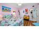 Bedroom with floral bedding, ceiling fan, and light wood floors at 5820 43Rd N Ter # 1403, St Petersburg, FL 33709