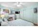 Bedroom with white dresser, sliding closet doors, and a light blue color scheme at 5820 43Rd N Ter # 1403, St Petersburg, FL 33709