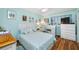 Light and airy bedroom with a light blue color scheme and white dresser at 5820 43Rd N Ter # 1403, St Petersburg, FL 33709