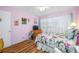 Bedroom with floral bedding, ceiling fan and light wood floors at 5820 43Rd N Ter # 1403, St Petersburg, FL 33709