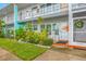 Inviting condo entrance with lush landscaping and rocking chairs at 5820 43Rd N Ter # 1403, St Petersburg, FL 33709