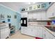 Bright white kitchen features stainless steel appliances and decorative backsplash at 5820 43Rd N Ter # 1403, St Petersburg, FL 33709