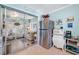 Kitchen includes stainless steel refrigerator and access to enclosed sunroom at 5820 43Rd N Ter # 1403, St Petersburg, FL 33709