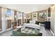 Bright sunroom with white couch and green accent chairs at 612 E Wheeler Rd, Seffner, FL 33584