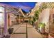 Outdoor patio area with pavers, string lights, seating, and lush tropical landscaping at 727 53Rd N Ter, St Petersburg, FL 33703