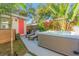 Backyard oasis featuring a hot tub, lounge chairs, and tropical landscaping for ultimate relaxation and privacy at 727 53Rd N Ter, St Petersburg, FL 33703