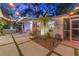 Charming backyard featuring tropical landscaping, pavers, and string lights for cozy evenings at 727 53Rd N Ter, St Petersburg, FL 33703