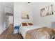 Inviting bedroom with wood floors, white walls, and stylish coastal decor with a peak to other rooms at 727 53Rd N Ter, St Petersburg, FL 33703