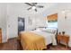 Bright bedroom featuring a cozy bed, wooden nightstand, ceiling fan, and a window for natural light at 727 53Rd N Ter, St Petersburg, FL 33703