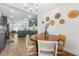 Charming dining area with a rustic wood table, wicker chairs, and decorative wall art near the modern kitchen at 727 53Rd N Ter, St Petersburg, FL 33703