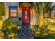 Eye-catching entryway with a red front door, lit stairs, and landscaped surroundings at 727 53Rd N Ter, St Petersburg, FL 33703