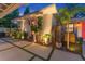 Charming home with a red door, lush landscaping, and decorative exterior lighting at 727 53Rd N Ter, St Petersburg, FL 33703