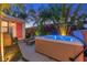 Backyard oasis with a hot tub, lounge chairs, and lush plants for relaxation at 727 53Rd N Ter, St Petersburg, FL 33703