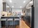 Modern kitchen boasts gray cabinets, stainless steel appliances, and a granite countertop island at 727 53Rd N Ter, St Petersburg, FL 33703
