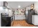 Updated kitchen with stainless steel appliances, white cabinets, and modern finishes at 727 53Rd N Ter, St Petersburg, FL 33703