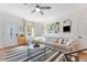 Bright living room with an L-shaped sofa, modern accents, and a view of the front yard at 727 53Rd N Ter, St Petersburg, FL 33703