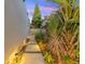 Well-lit walkway with paver stones, lush tropical plants, and a private fenced entrance at 727 53Rd N Ter, St Petersburg, FL 33703