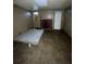 Unfinished basement with tiled floor, fireplace and mattress. Needs renovation at 8204 N Klondyke St, Tampa, FL 33604