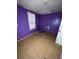 Small bedroom with purple walls and hardwood floors. Needs cleaning and repair at 8204 N Klondyke St, Tampa, FL 33604