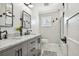 Modern bathroom with gray cabinets, marble countertops, and black accents at 8215 Cosme Rd, Odessa, FL 33556