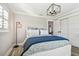 Guest bedroom with a white bed frame and blue bedding, featuring a window with shutters at 8215 Cosme Rd, Odessa, FL 33556