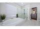 Spa-like bathroom with soaking tub and walk-in shower at 9625 Gretna Green Dr, Tampa, FL 33626