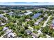 Expansive aerial view of a residential neighborhood with a community lake and mature trees at 980 5Th Ne Ave, Largo, FL 33770