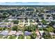 An elevated neighborhood shot displays uniform homes with verdant lawns and mature, shading trees at 980 5Th Ne Ave, Largo, FL 33770