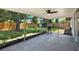 Covered screened-in porch with a chair overlooking the spacious fenced backyard at 980 5Th Ne Ave, Largo, FL 33770