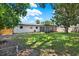 Exterior view of home and screened patio with a well-maintained backyard at 980 5Th Ne Ave, Largo, FL 33770