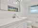 Bathroom featuring a mirror, modern vanity, and a shower with colorful curtain at 980 5Th Ne Ave, Largo, FL 33770