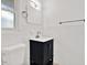 Bathroom with a single vanity, mirror and white tiled walls at 980 5Th Ne Ave, Largo, FL 33770