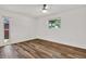 Comfortable bedroom featuring wood-look flooring, a ceiling fan, and natural light at 980 5Th Ne Ave, Largo, FL 33770