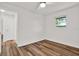 Bright bedroom featuring wood floors, a ceiling fan, and a window at 980 5Th Ne Ave, Largo, FL 33770