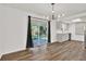 Dining area with patio access, modern lighting, and wood-look floors at 980 5Th Ne Ave, Largo, FL 33770