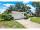 A charming home with a well-manicured lawn and an attached one-car garage at 980 5Th Ne Ave, Largo, FL 33770