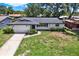 Landscaped front yard and exterior view of the charming one-story house at 980 5Th Ne Ave, Largo, FL 33770