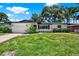 Charming single-story home with a well-manicured lawn and beautiful landscaping at 980 5Th Ne Ave, Largo, FL 33770