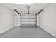 View of the home's spacious garage with epoxy floor and a white door at 980 5Th Ne Ave, Largo, FL 33770