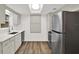 Updated kitchen with stainless steel appliances, light cabinets, and a skylight at 980 5Th Ne Ave, Largo, FL 33770