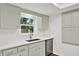 Modern kitchen with white countertops, stainless steel appliances, and ample storage at 980 5Th Ne Ave, Largo, FL 33770