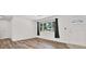 Cozy living room with natural light and wood-look flooring adjacent to the entryway at 980 5Th Ne Ave, Largo, FL 33770