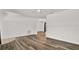 Bright open-concept living room featuring wood-look floors and modern ceiling fan at 980 5Th Ne Ave, Largo, FL 33770