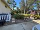 Charming backyard with a wishing well feature, manicured bushes, and partial white picket fence at 11405 Warm Wind Way, Weeki Wachee, FL 34613