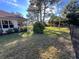 Expansive backyard featuring well-kept lawn, mature trees, and partial fence-line at 11405 Warm Wind Way, Weeki Wachee, FL 34613