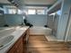 Spacious bathroom with double sinks, a bathtub, and a separate shower at 11405 Warm Wind Way, Weeki Wachee, FL 34613