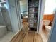 Bathroom closet with built-in shelves and mirrored door at 11405 Warm Wind Way, Weeki Wachee, FL 34613