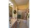 Bright bathroom with a vanity, tub-shower combination, and decorative sunflower wreath at 11405 Warm Wind Way, Weeki Wachee, FL 34613
